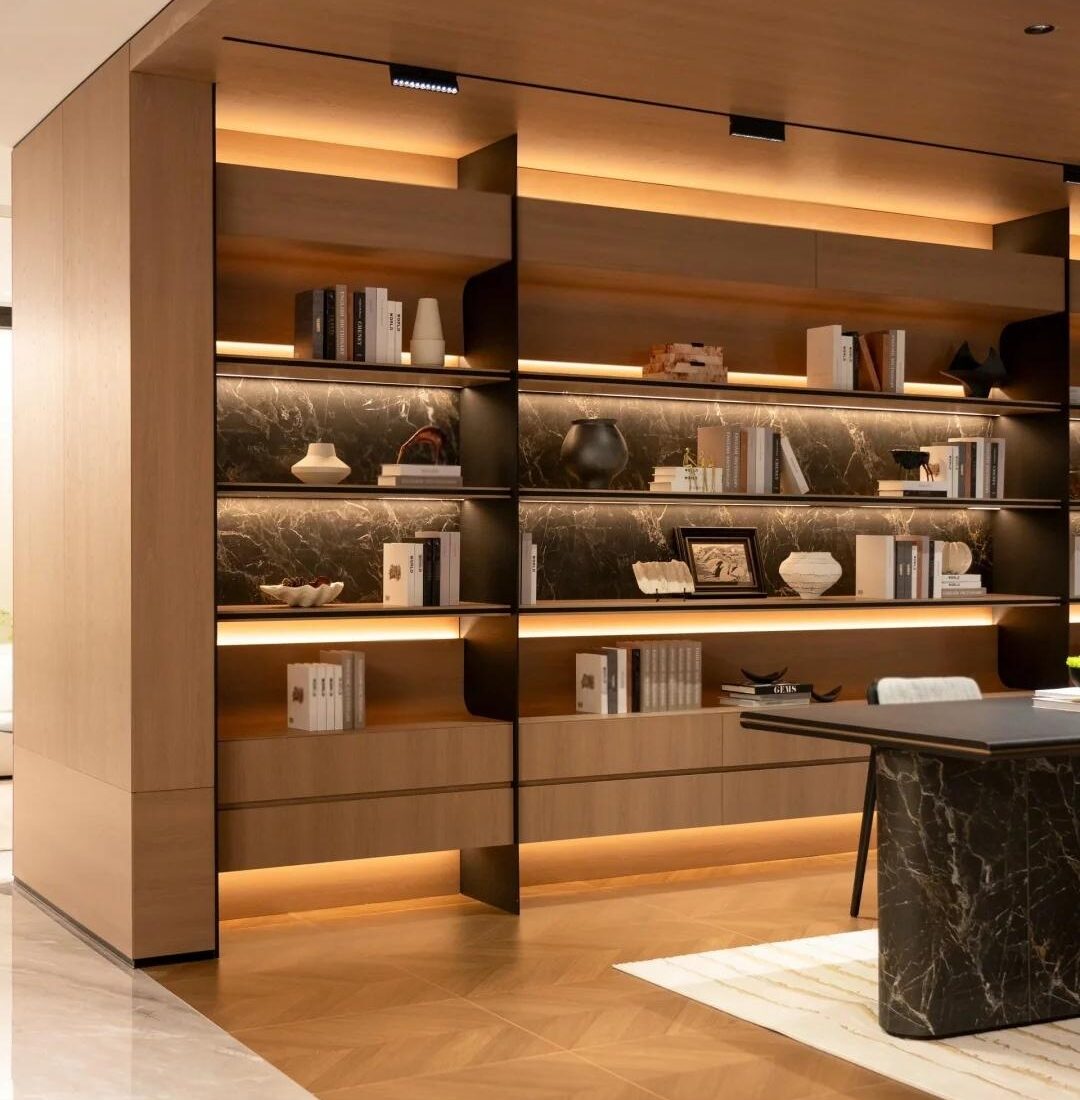 Library-style timber display area inside the HENNISSY Foshan headquarters showroom