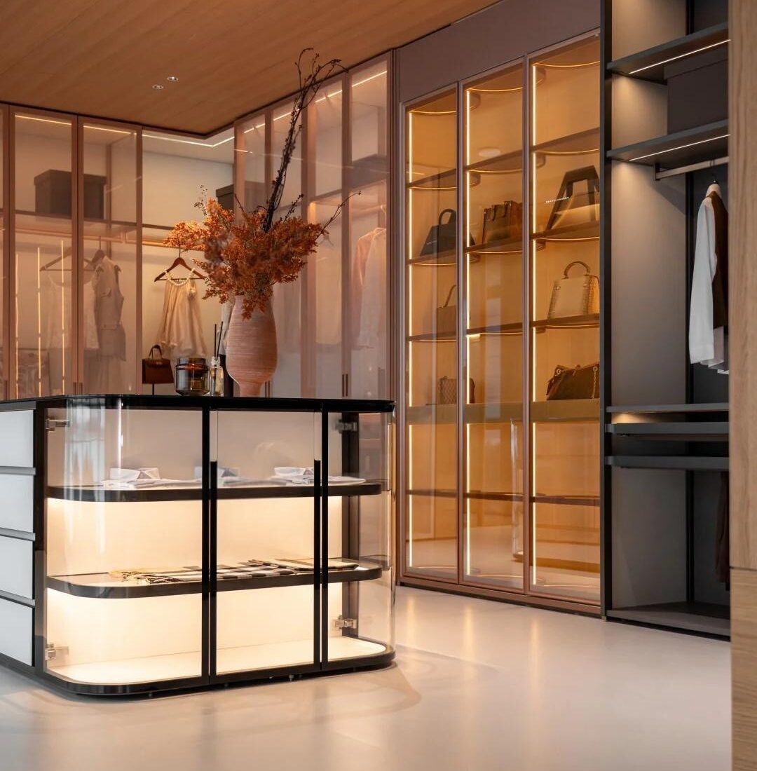 Illuminated wardrobe and glazed cabinet display inside the HENNISSY Foshan headquarters showroom