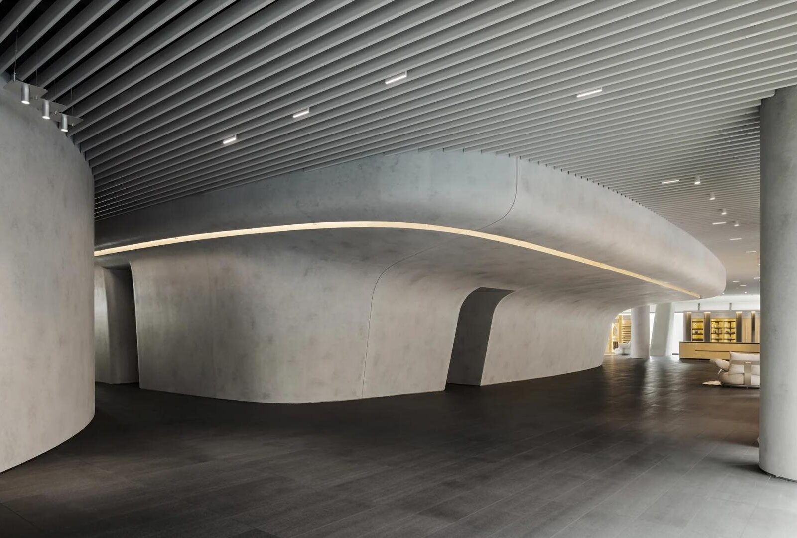 Curved concrete gallery space inside the HIGOLD Future Hardware Pavilion in Foshan