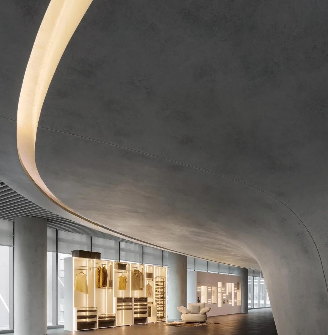 Illuminated wardrobe and storage system display beneath a curved ceiling at the HIGOLD Future Hardware Pavilion