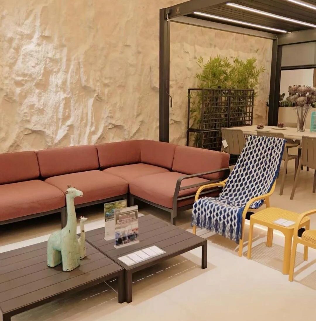 Outdoor sectional, accent chair and pergola display inside the HOWVIN sequence at Foshan Louvre